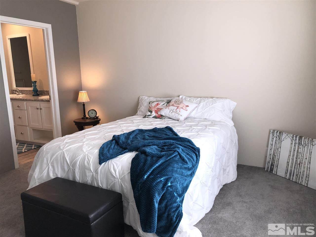 15380 Tuxon Way Reno, NV 89521 - Photo 13 of 25 a bed sitting in a bedroom and a lamp
