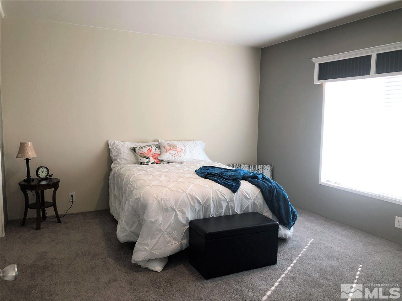 15380 Tuxon Way Reno, NV 89521 - Photo 14 of 25 a bed sitting in a bedroom next to a window