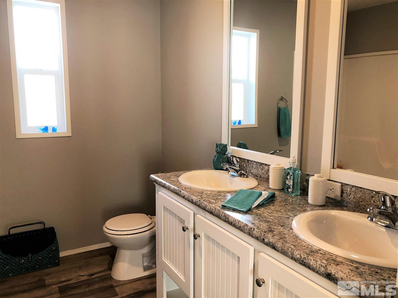 15380 Tuxon Way Reno, NV 89521 - Photo 17 of 25 a bathroom with a granite countertop sink and a mirror