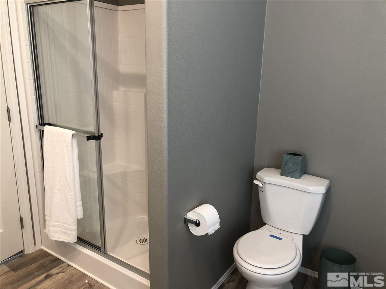 15380 Tuxon Way Reno, NV 89521 - Photo 18 of 25 a white toilet sitting next to a bathroom sink