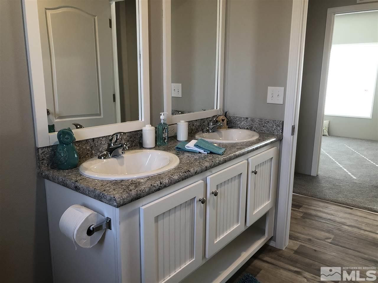 15380 Tuxon Way Reno, NV 89521 - Photo 21 of 25 a bathroom with sinks granite countertop a sink and a mirror