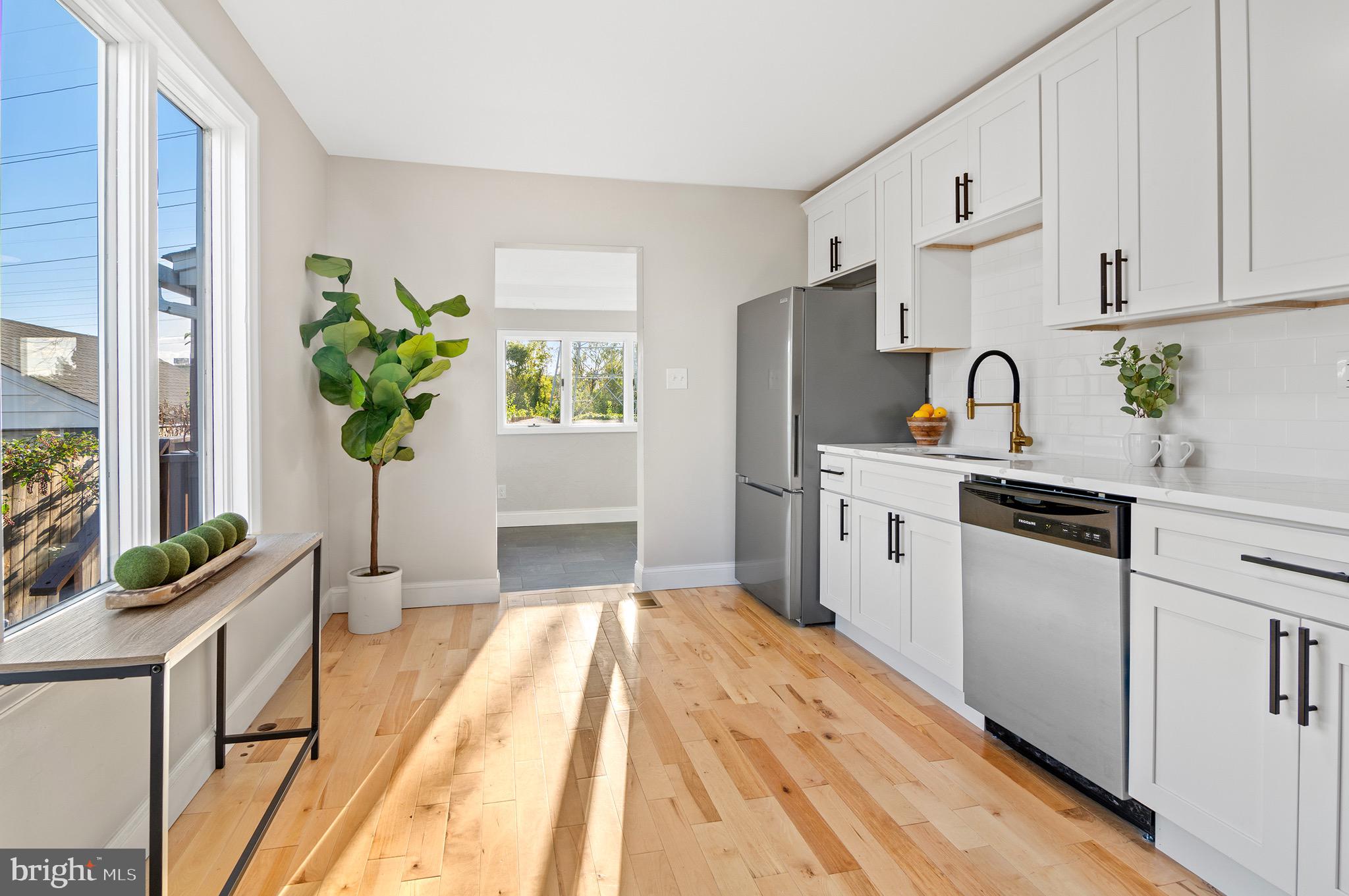 1237 Willow Road Dundalk, MD 21222 - Photo 15 of 29 a kitchen with stainless steel appliances a sink a counter top space cabinets and a window