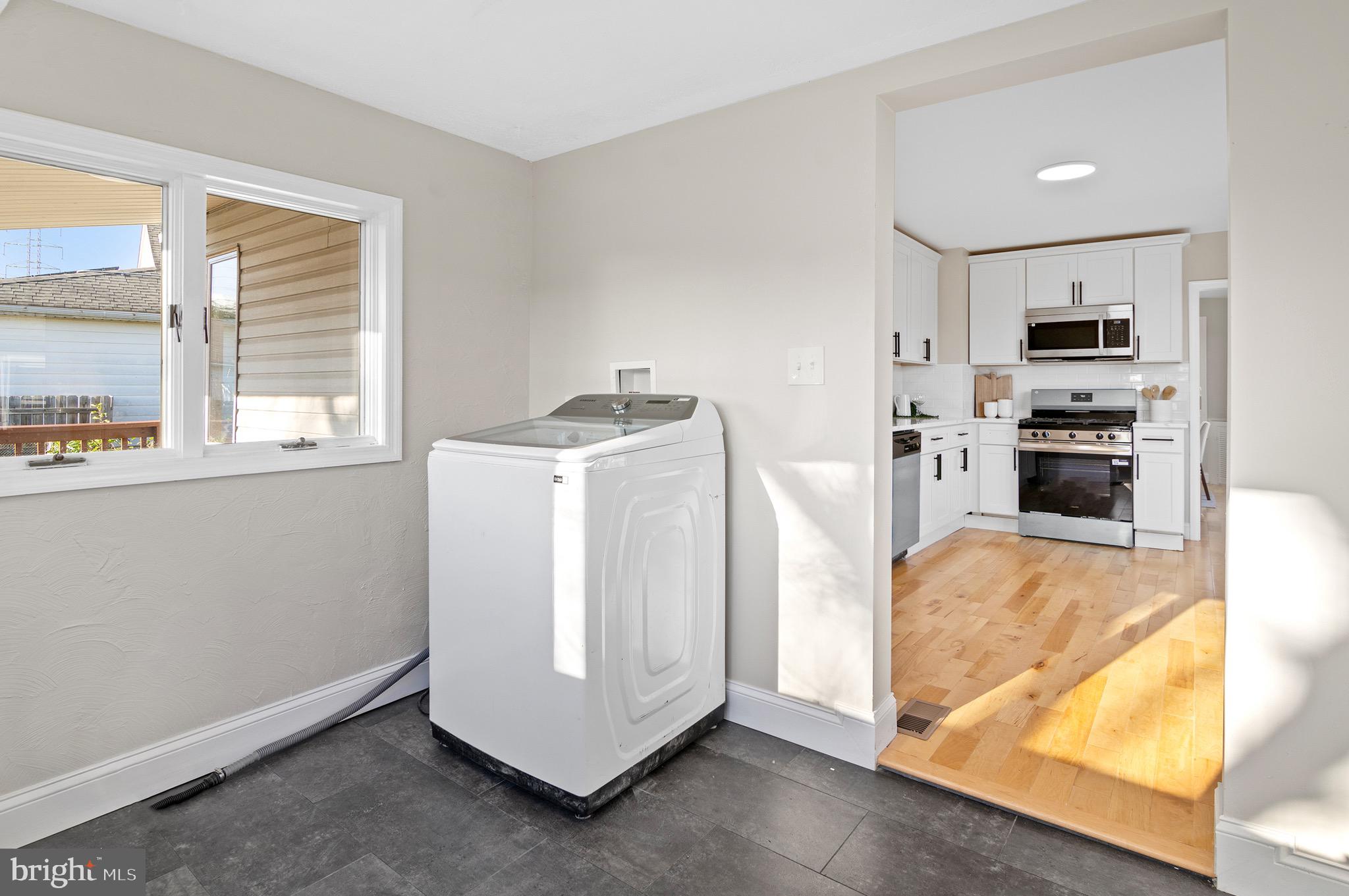 1237 Willow Road Dundalk, MD 21222 - Photo 16 of 29 a view of kitchen with stainless steel appliances wooden floor and window
