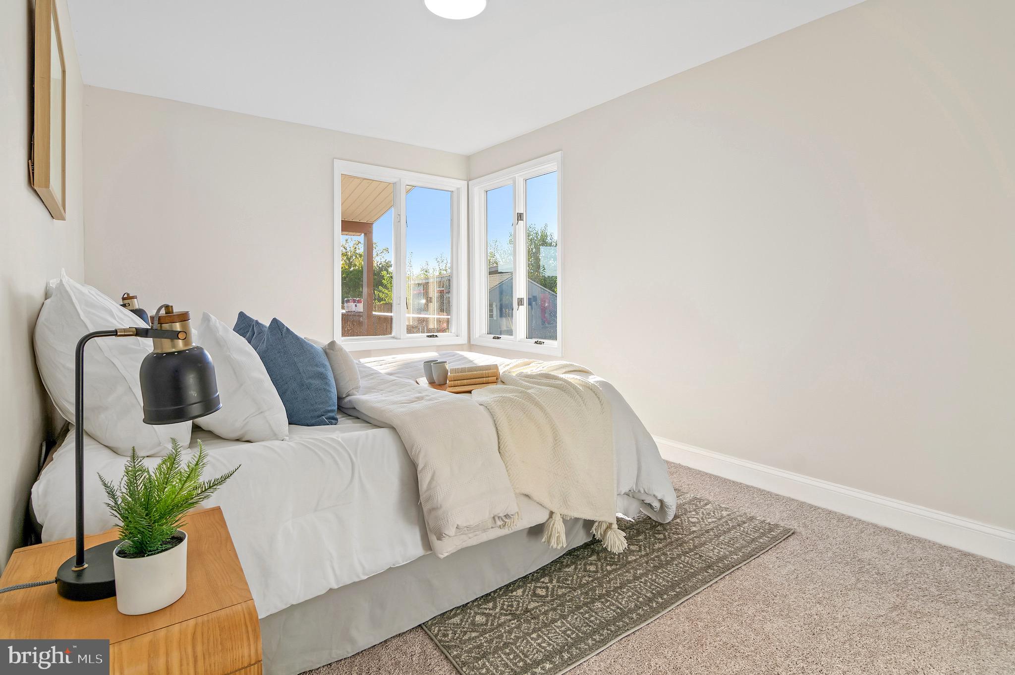 1237 Willow Road Dundalk, MD 21222 - Photo 22 of 29 a bed sitting in a bedroom next to a window