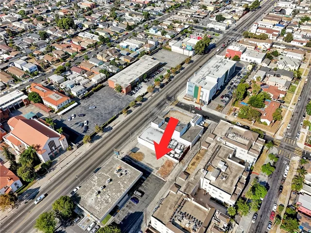 an aerial view of a building with parking