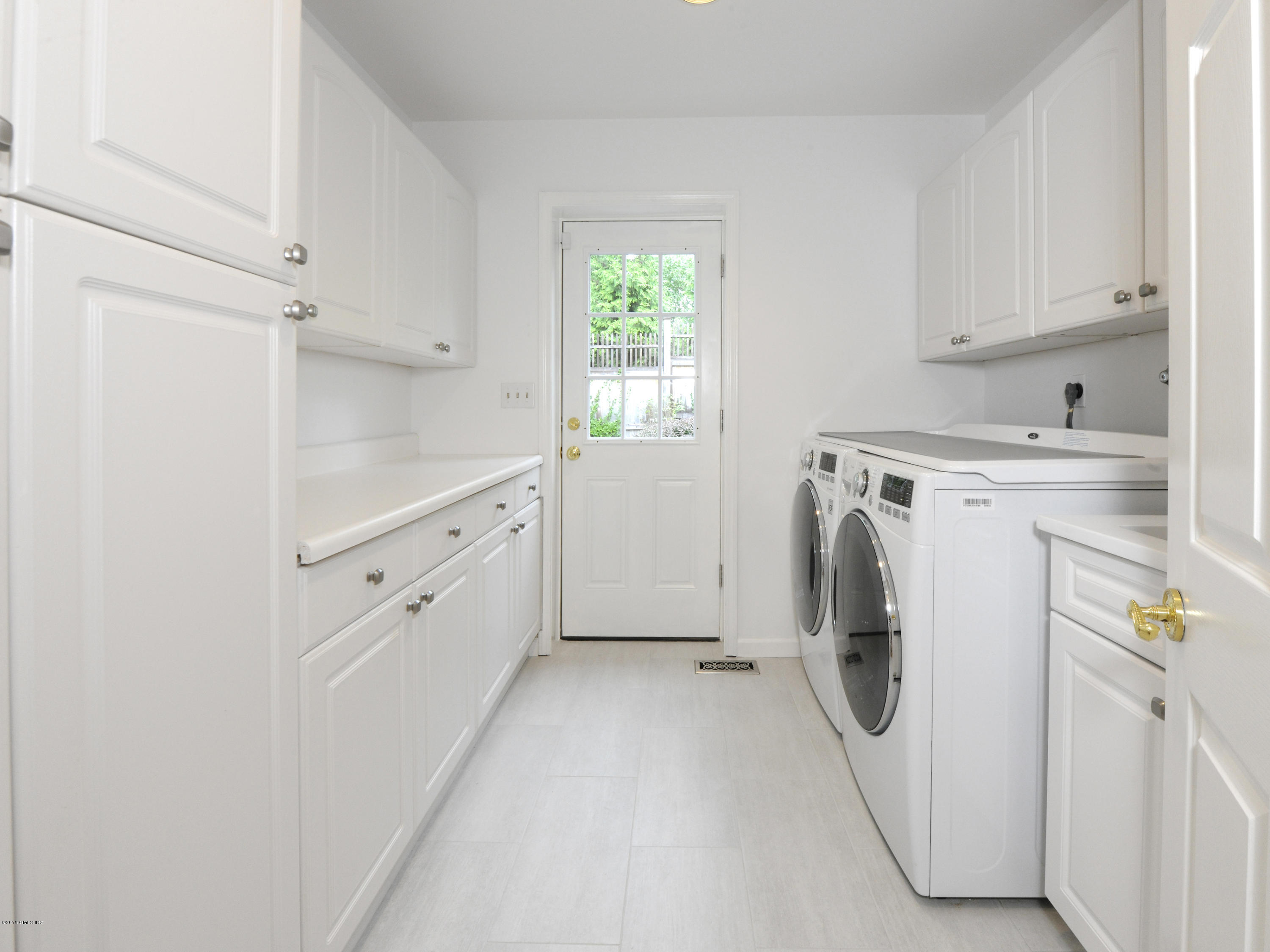 9 Palmer Lane Riverside, CT 06878 - Photo 11 of 29 a view of a storage and utility room with washer and dryer