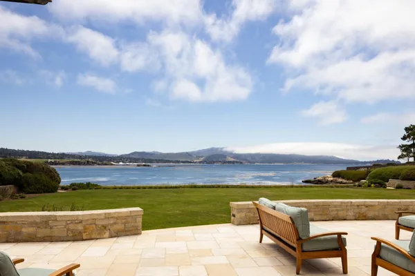a view of swimming pool with lounge chair and lake view