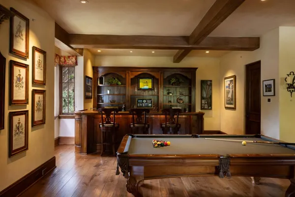 a living room with fireplace furniture and wooden floor