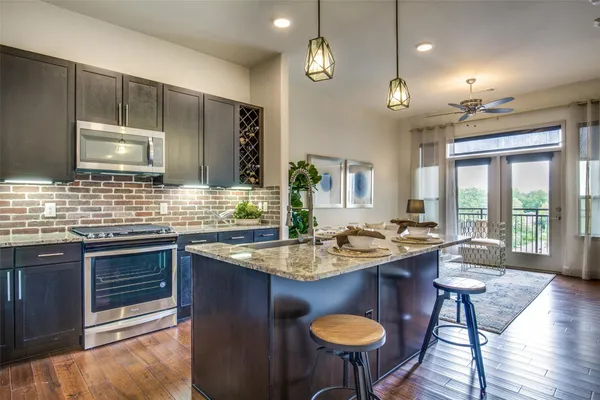 a kitchen with sink stove dining table and chairs