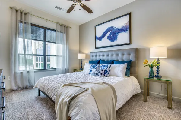 a bedroom with a bed and a painting on the wall