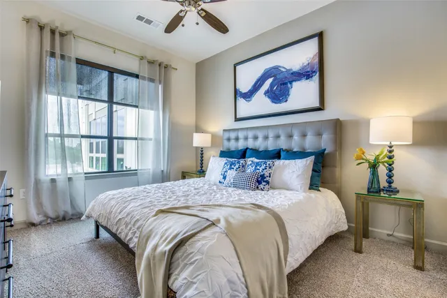 a bedroom with a bed and a painting on the wall