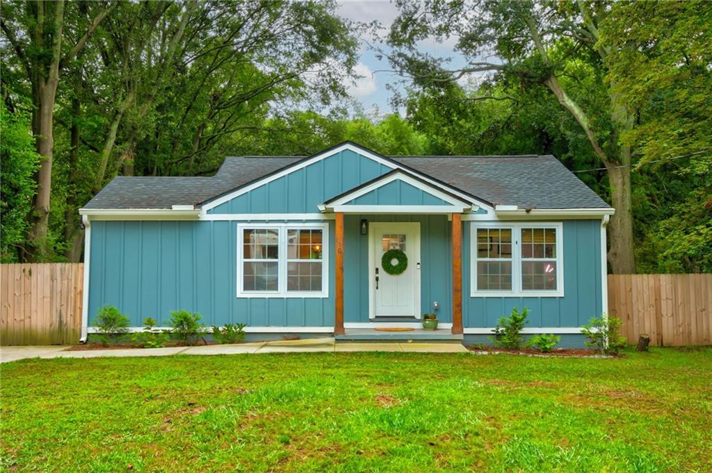 a front view of a house with a garden