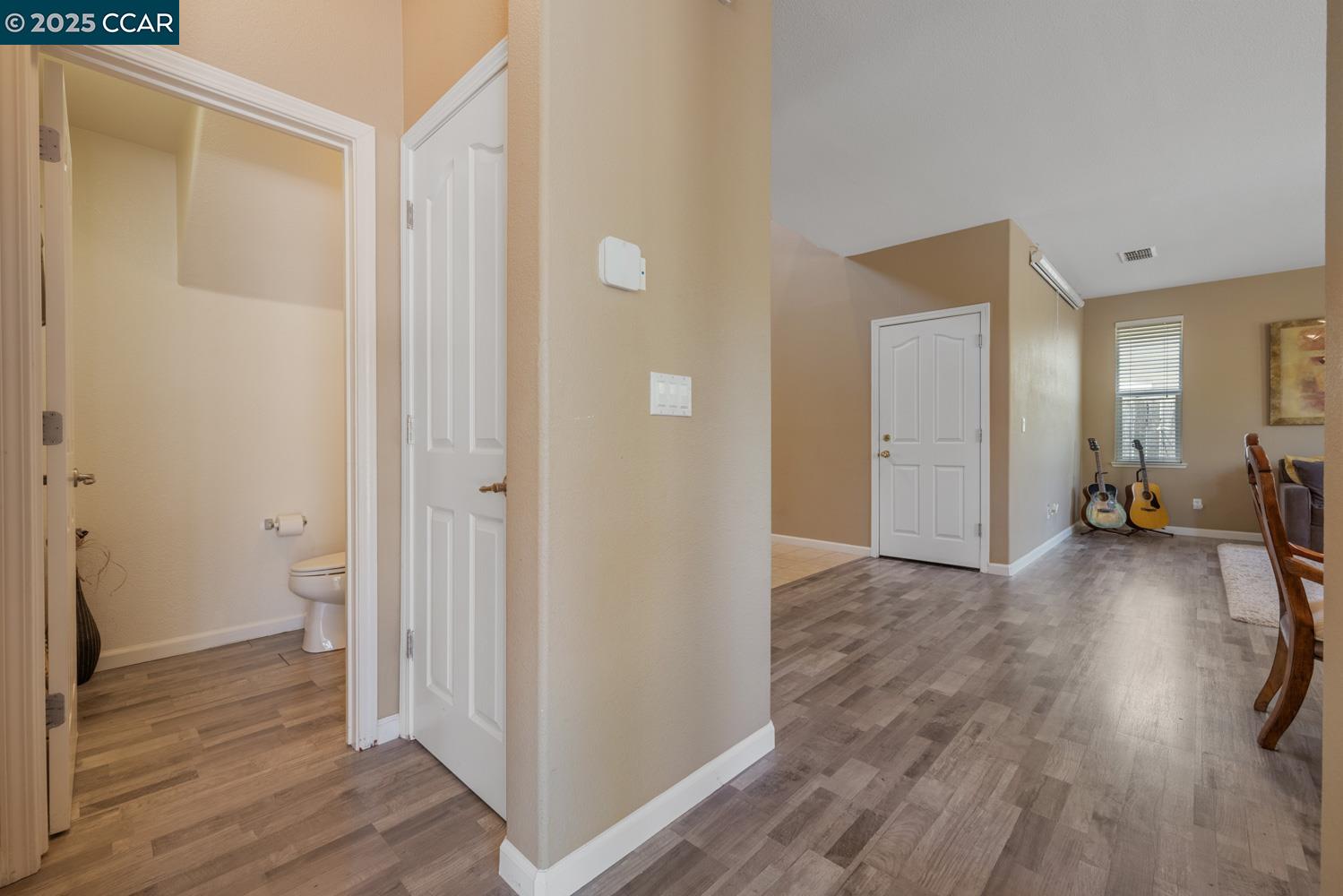 1117 Van Gogh Lane Patterson, CA 95363 - Photo 11 of 55 a view of a room with wooden floor and a bathroom