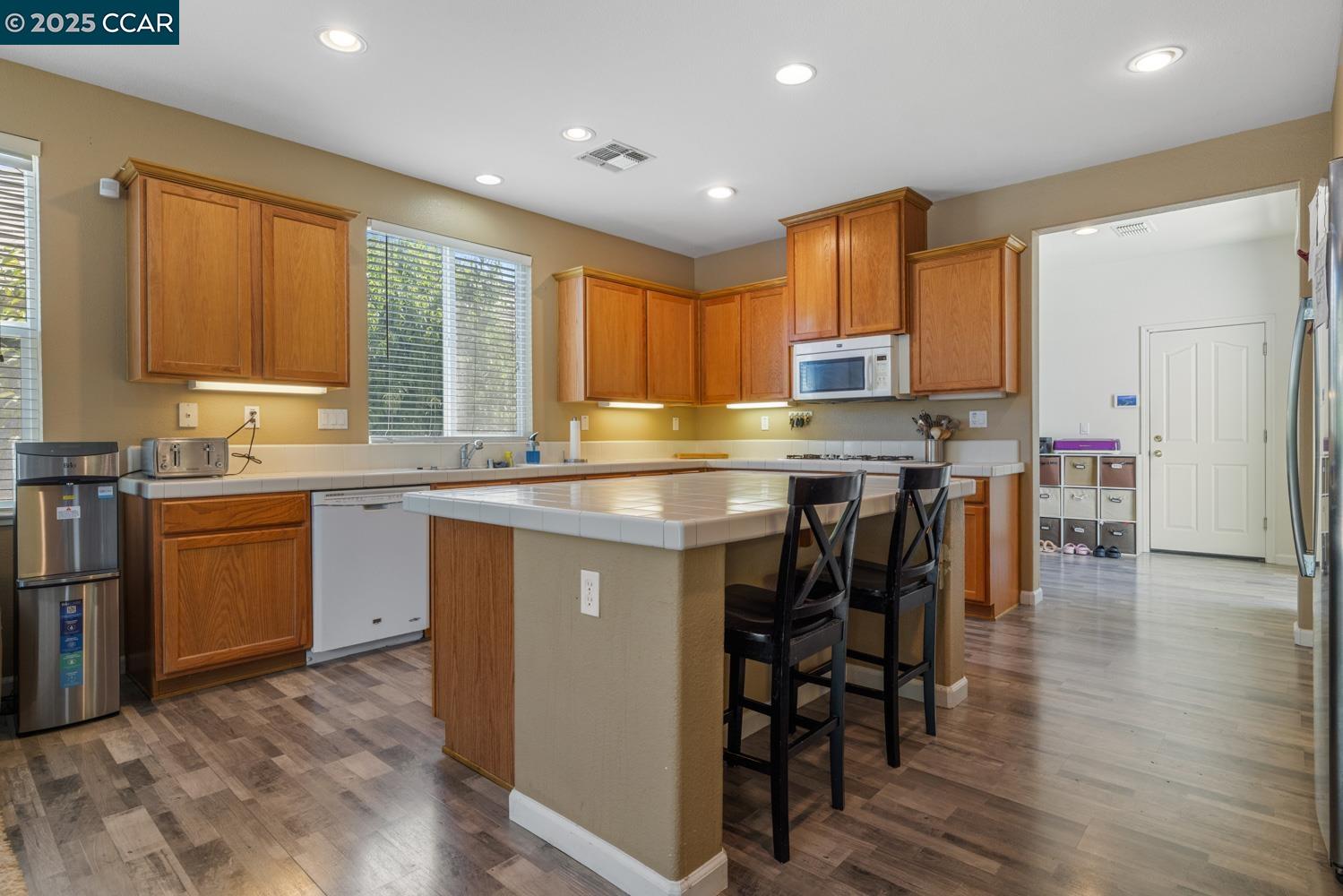 1117 Van Gogh Lane Patterson, CA 95363 - Photo 20 of 55 a kitchen with a sink window and cabinets