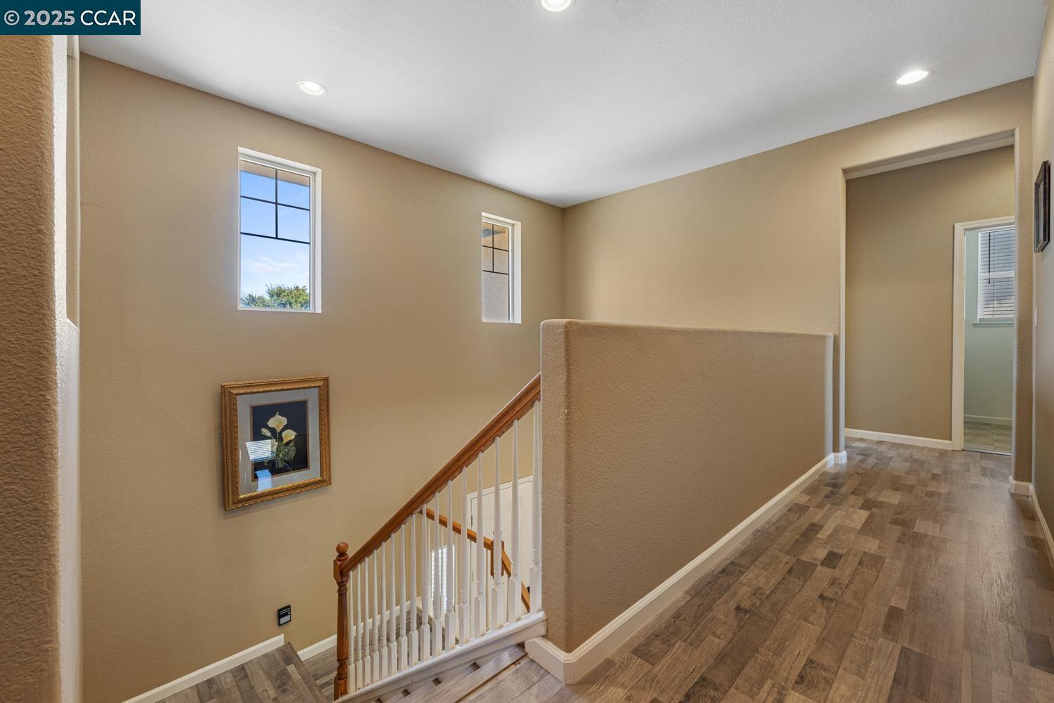 1117 Van Gogh Lane Patterson, CA 95363 - Photo 23 of 55 a view of hallway with wooden floor and stairs