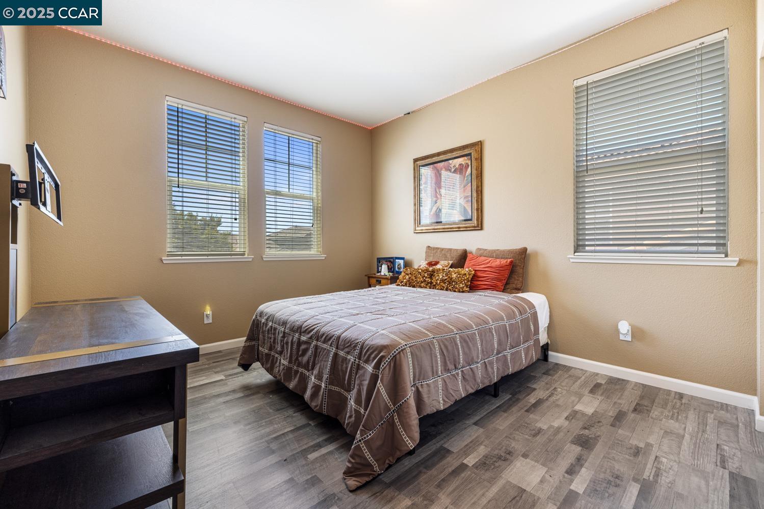 1117 Van Gogh Lane Patterson, CA 95363 - Photo 25 of 55 a bedroom with a bed and a window
