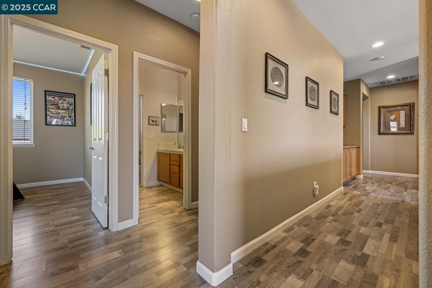 1117 Van Gogh Lane Patterson, CA 95363 - Photo 26 of 55 a view of livingroom with hardwood floor and hallway