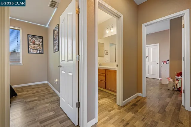 a white toilet sitting next to a bath tub and a window