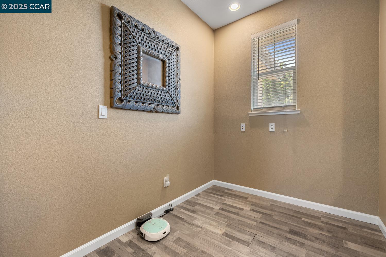 1117 Van Gogh Lane Patterson, CA 95363 - Photo 35 of 55 a view of an empty room with window and wooden floor