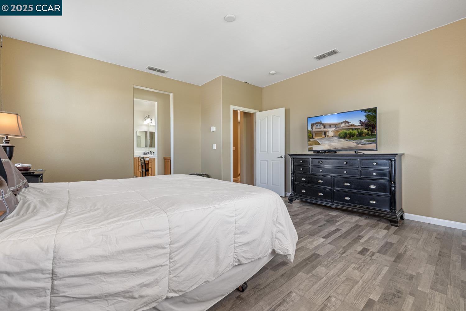 1117 Van Gogh Lane Patterson, CA 95363 - Photo 38 of 55 a bedroom with a bed and a dresser