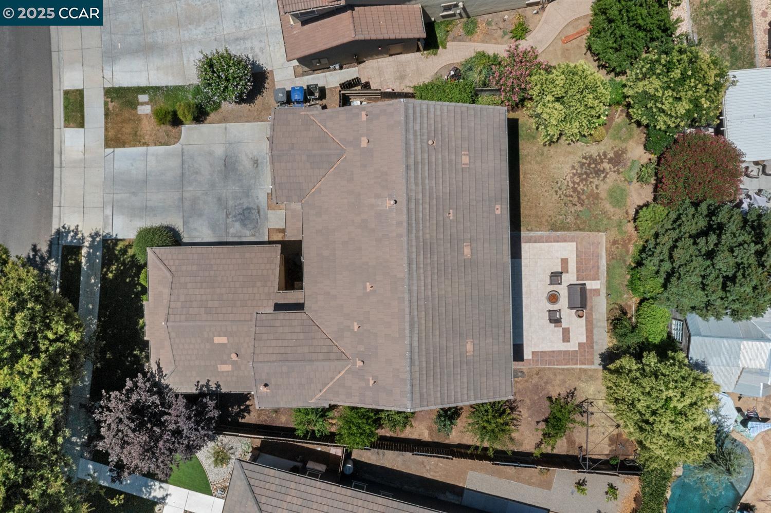 1117 Van Gogh Lane Patterson, CA 95363 - Photo 47 of 55 an aerial view of a house with a yard and large trees