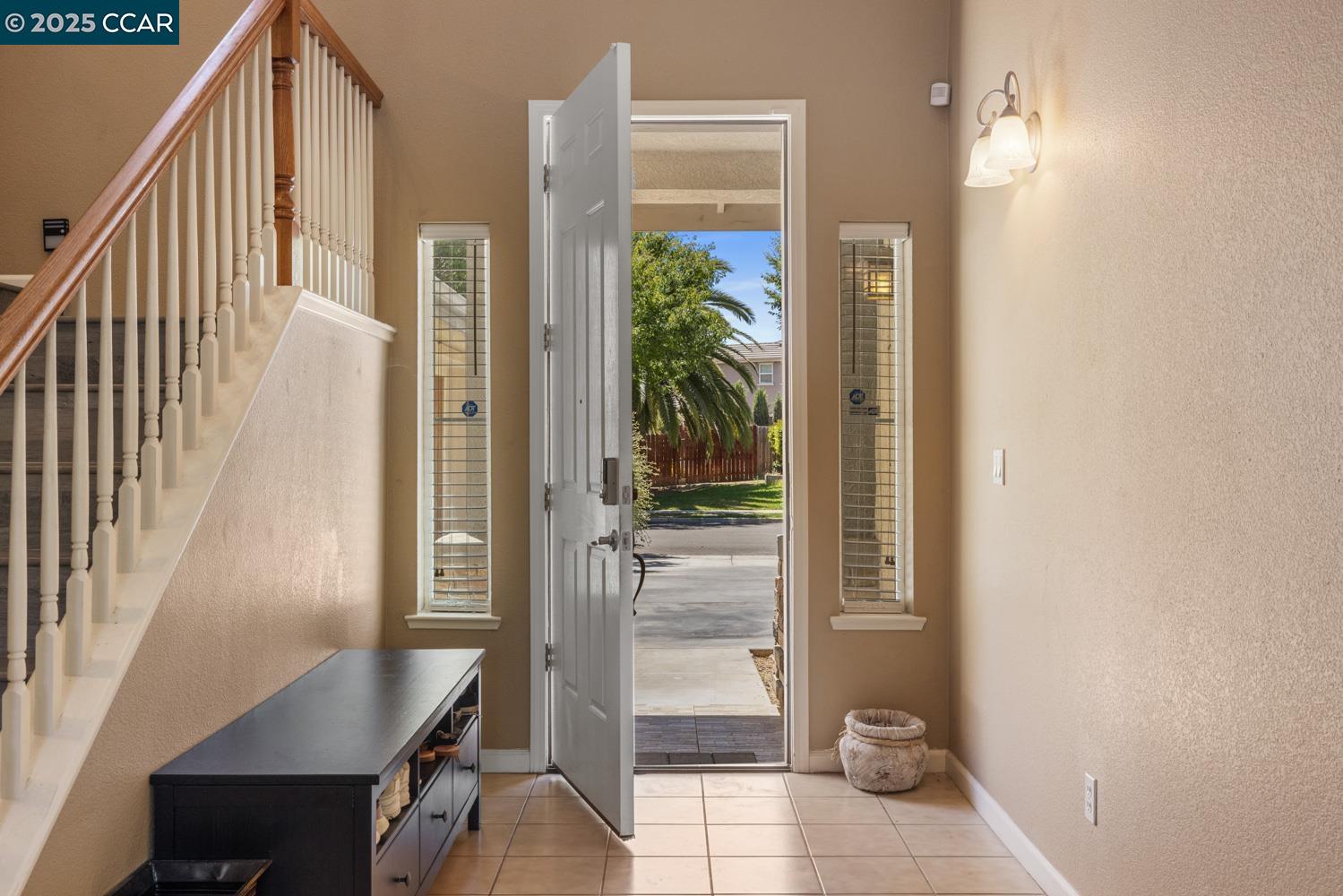 1117 Van Gogh Lane Patterson, CA 95363 - Photo 6 of 55 a view of a hallway with wooden floor and staircase