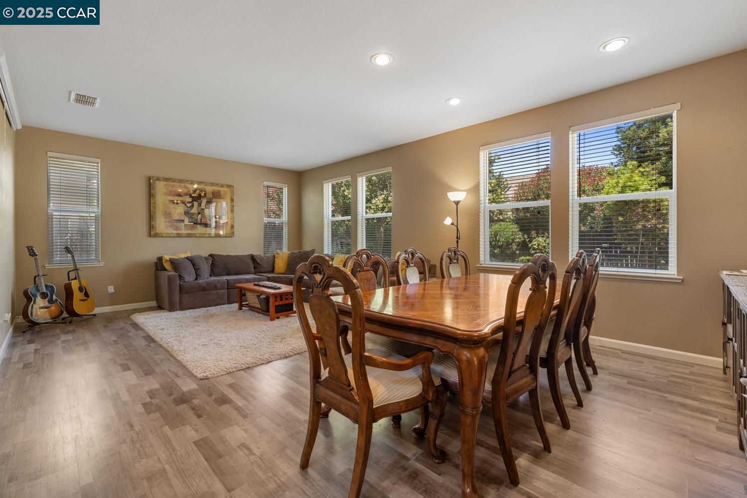 1117 Van Gogh Lane Patterson, CA 95363 - Photo 7 of 55 a dining room with furniture and wooden floor