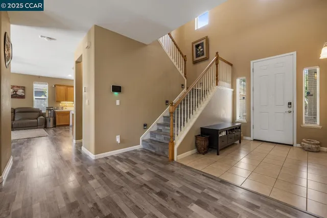 a view of a room with wooden floor and a bathroom