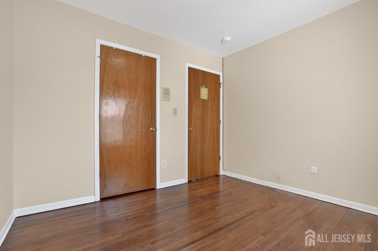 1 Wakefield Drive Edison, NJ 08820 - Photo 22 of 29 a view of an empty room with wooden floor and closet
