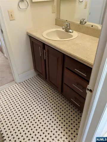 a bathroom with a sink a toilet and a mirror