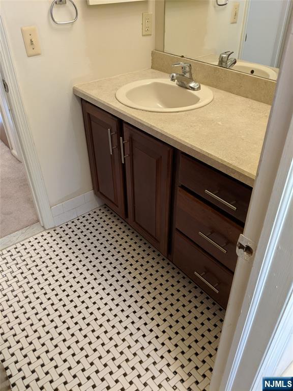 39-1 Smith Street Waldwick, NJ 07463 - Photo 12 of 37 a bathroom with a sink a toilet and a mirror