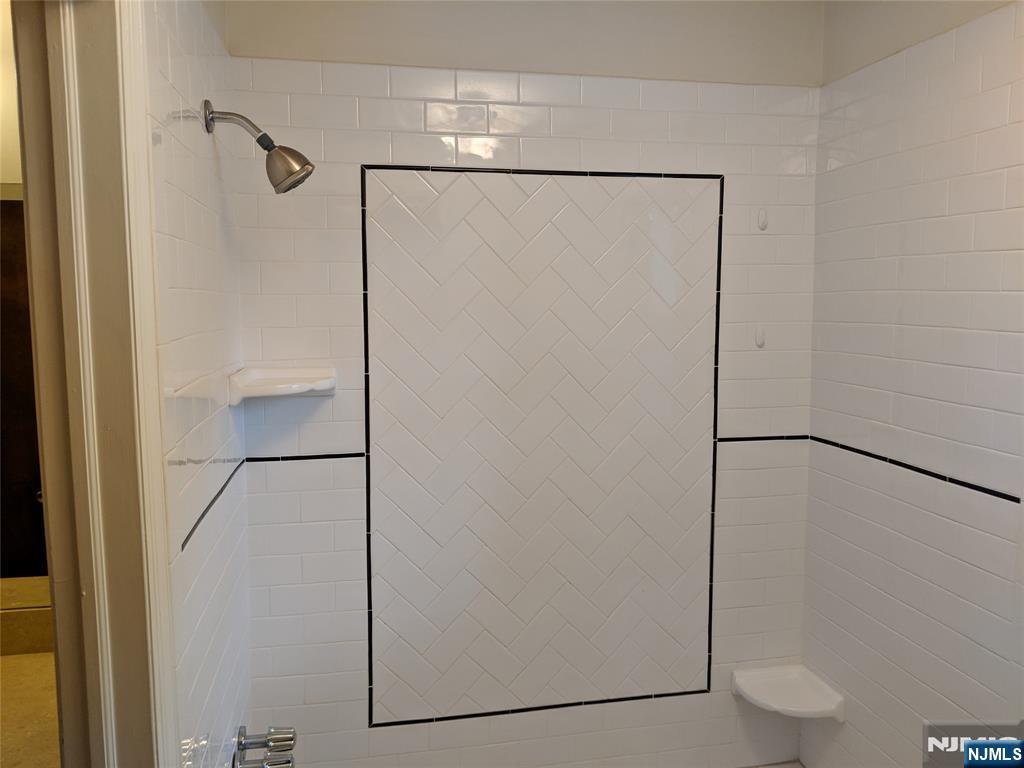 39-1 Smith Street Waldwick, NJ 07463 - Photo 14 of 37 a bathroom with a glass shower door