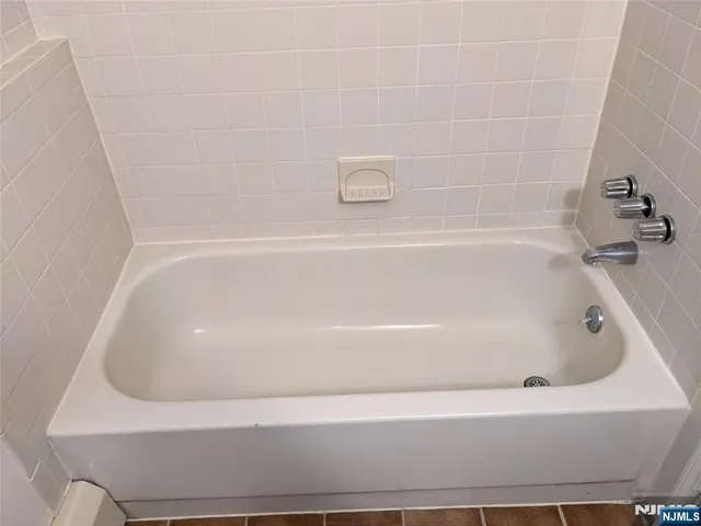 a close view of a bathtub in bathroom