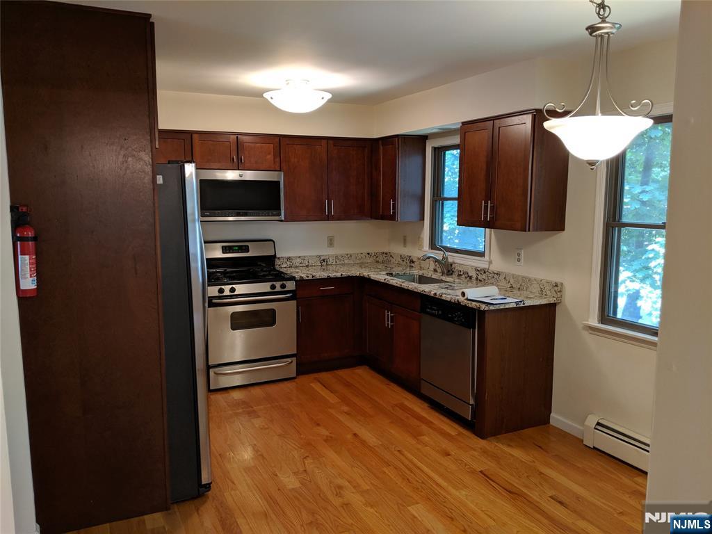 39-1 Smith Street Waldwick, NJ 07463 - Photo 4 of 37 a kitchen with granite countertop a stove and a refrigerator