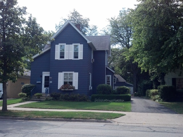 107 Lawton Road Riverside, IL 60546 - Photo 1 of 17 a front view of a house with a garden and trees