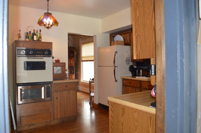 107 Lawton Road Riverside, IL 60546 - Photo 7 of 17 a kitchen with stainless steel appliances granite countertop a refrigerator and a stove top oven