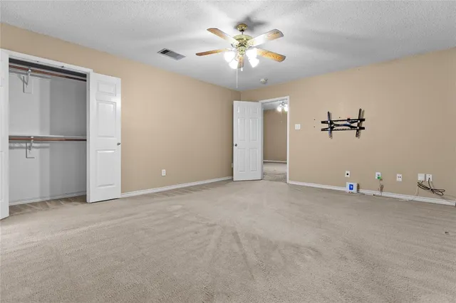 a view of a livingroom with a chandelier fan