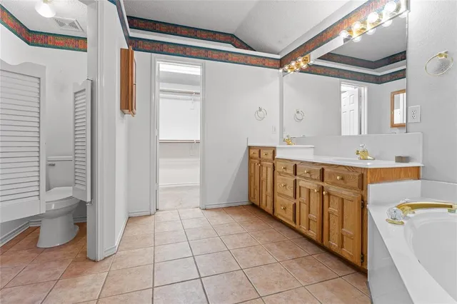 a bathroom with a double vanity sink toilet and shower