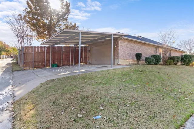 a view of a small house with a yard
