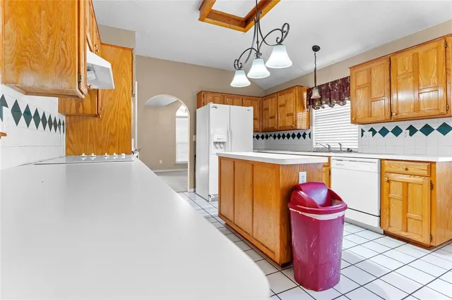 a kitchen with a stove a sink and a refrigerator