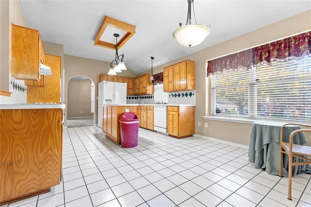 a kitchen with stainless steel appliances kitchen island granite countertop a refrigerator and a stove