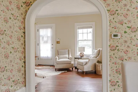 a view of a hallway view with wooden floor and furniture