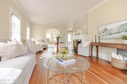 a living room with furniture and wooden floor