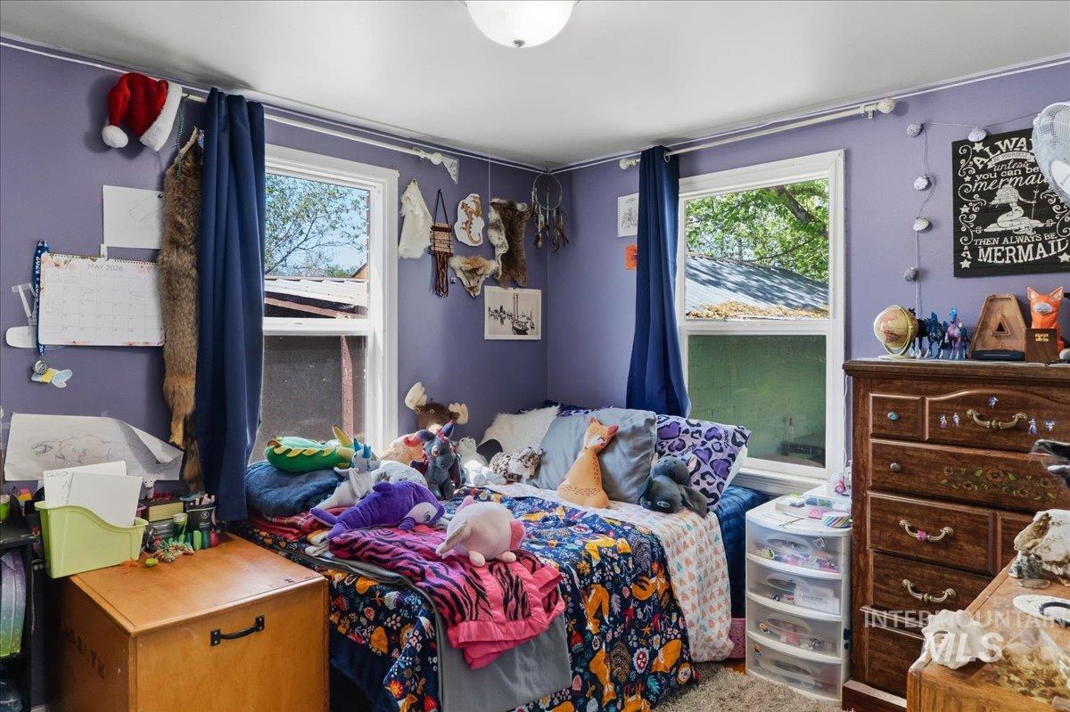 1958 East 1775 South Gooding, ID 83330 - Photo 26 of 49 Room with two double-hung windows, a ceiling-mounted light fixture, and light purple wall color