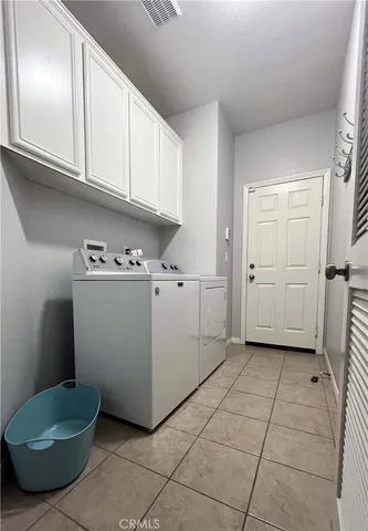 a view of a storage & utility room with cabinets