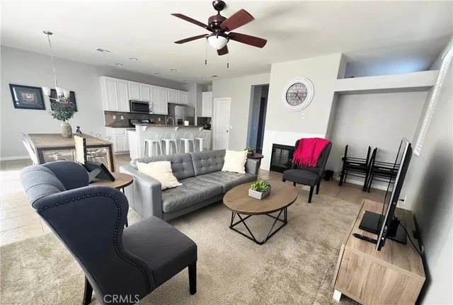 a living room with furniture and kitchen view