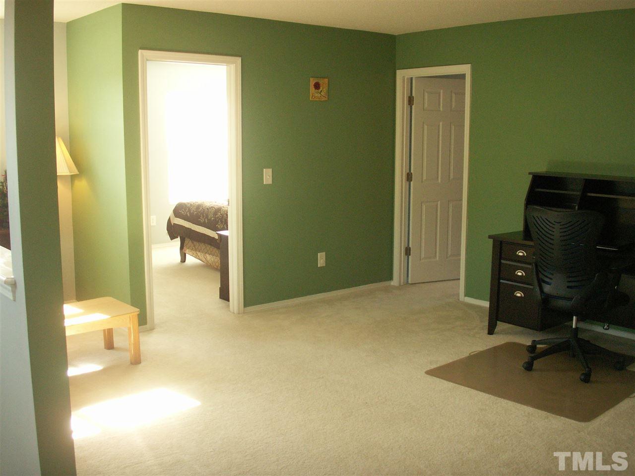 3129 Varcroft Road Knightdale, NC 27545 - Photo 13 of 25 a bedroom with a bed and furniture