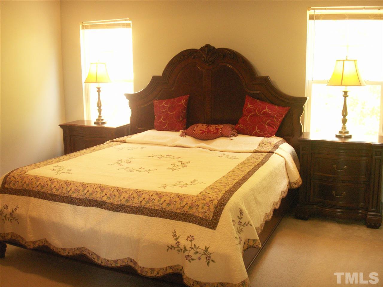 3129 Varcroft Road Knightdale, NC 27545 - Photo 14 of 25 a large bed sitting in a bedroom next to a window