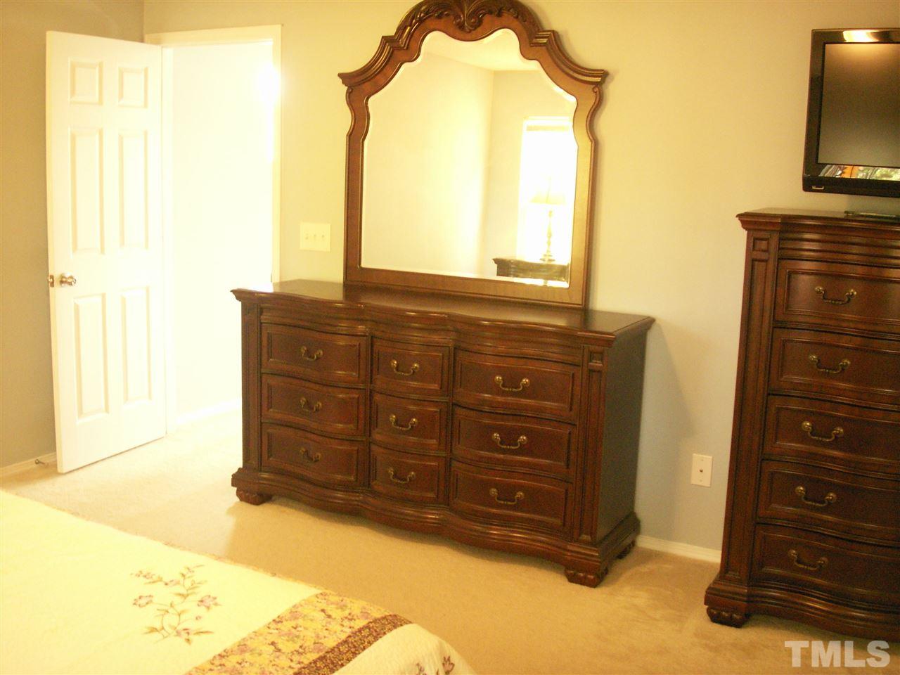 3129 Varcroft Road Knightdale, NC 27545 - Photo 15 of 25 a view of a dresser with mirror