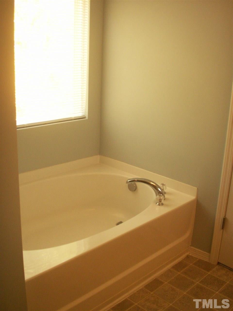3129 Varcroft Road Knightdale, NC 27545 - Photo 17 of 25 a bathroom with a bathtub